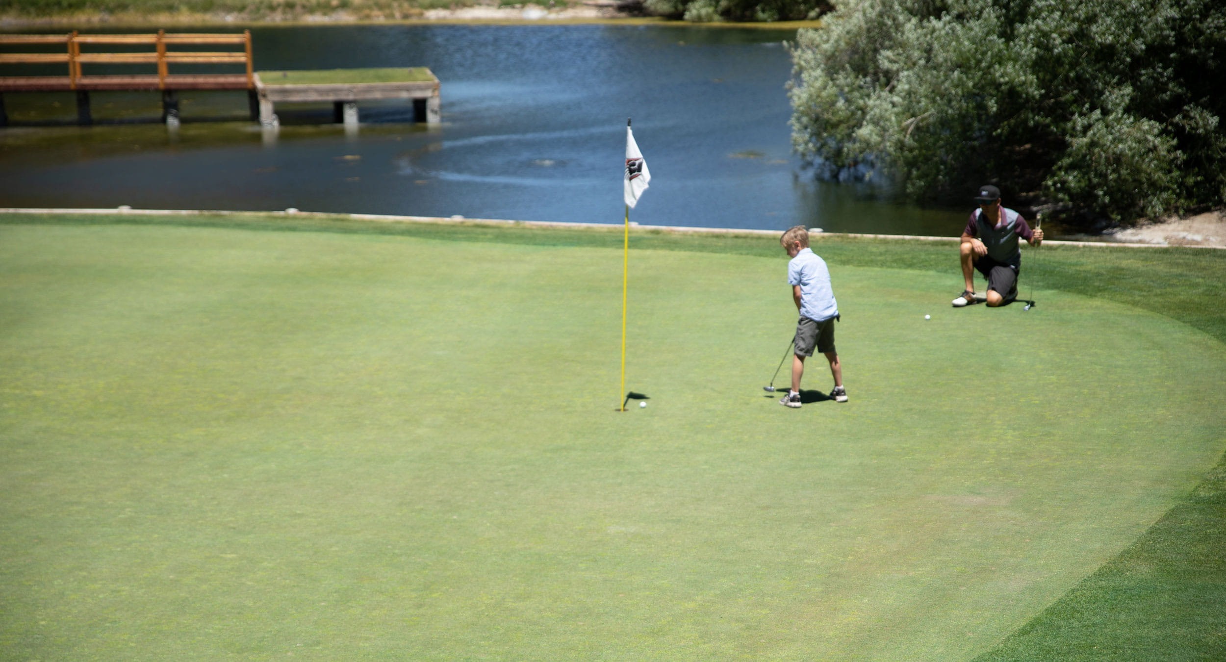 Dad and son playing golf